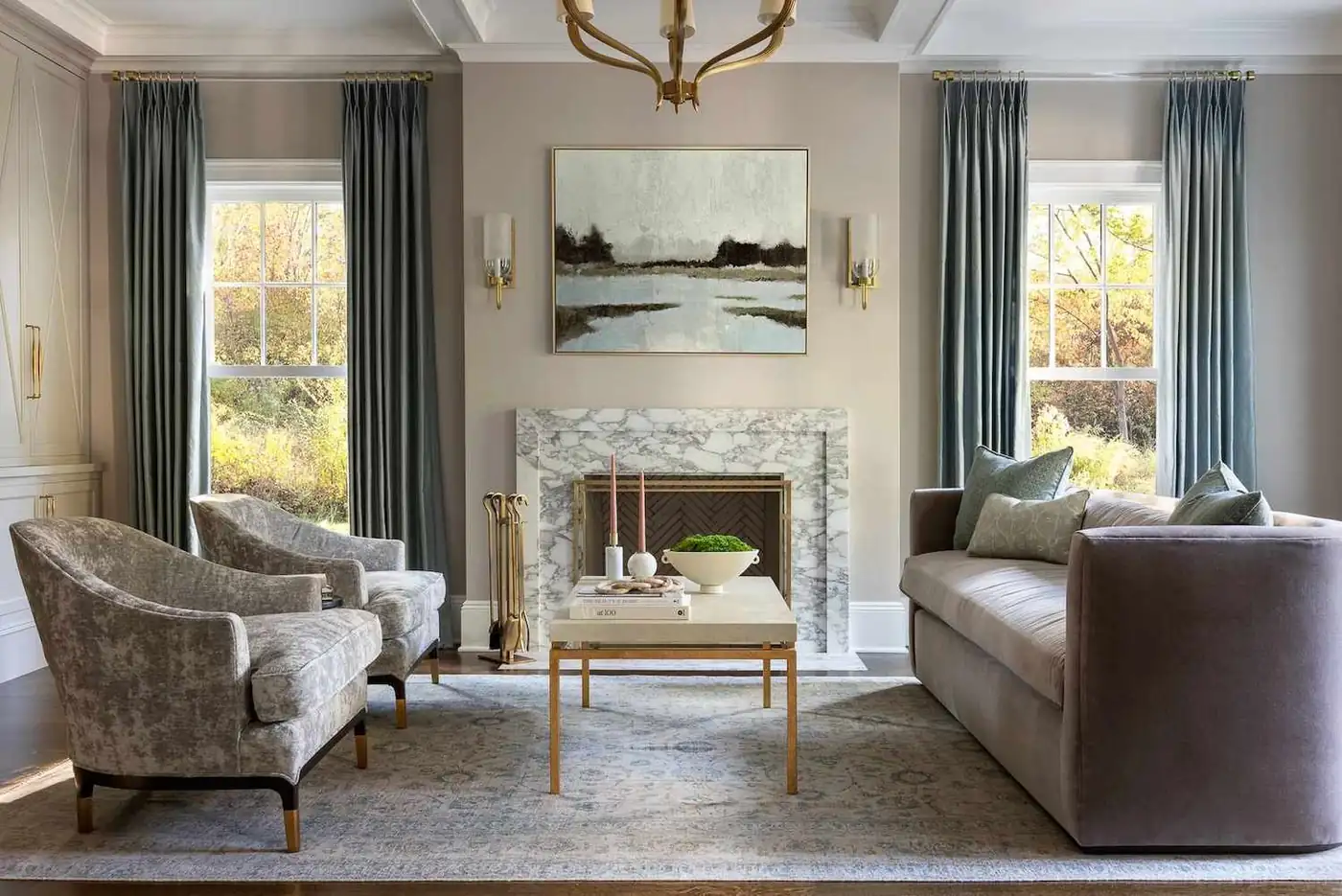 Blue-gray curtains frame two windows beside a fireplace in a gray living room.
