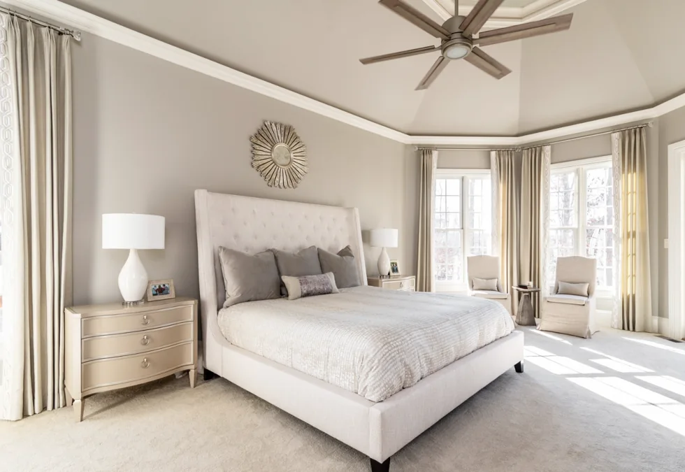 A low three-drawer chest serves as a bedside table beside the bed.