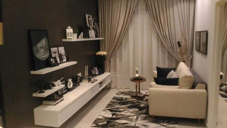 A cream sofa faces a dark wall with floating shelves above a long white cabinet.